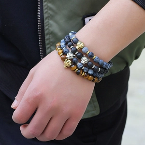 Men's set of four beaded bracelets with tiger eye, lava stone, and leopard head charms