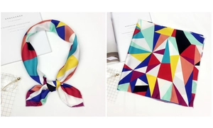 Detailed view of square satin scarf featuring bright geometric color block patterns