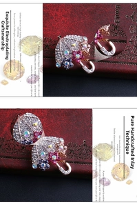 Dettaglio spilla a ombrello in lega con strass multicolori e struttura in metallo placcato