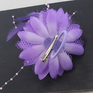 Purple flower hair accessory with feathers, lace petals and beads for dance performances