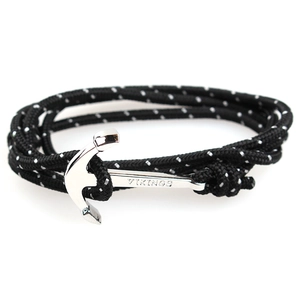 Detail of black woven rope bracelet with silver anchor pendant and VIKINGS engraving