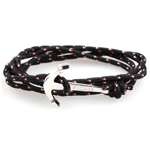 Detail of silver viking anchor clasp with Vikings engraving on red and white cord bracelet