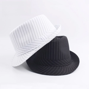 Detailed close-up of striped jazz fedora hats in black and white with decorative bands