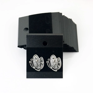 Vintage silver butterfly stud earrings with grey rhinestones on black display cards