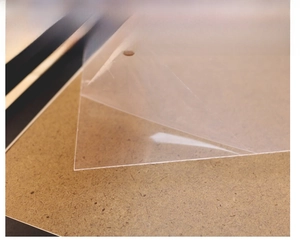 Close-up showing removal of protective film from the transparent photo frame panel