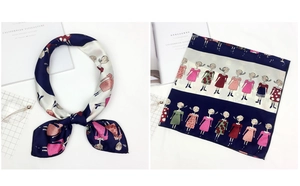 Detailed close-up of a satin square scarf featuring cartoon girl illustrations and navy stripes