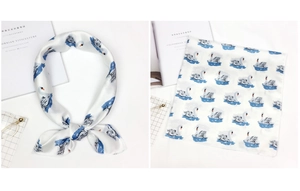 Detail of silk square scarf with blue swan print showing both knotted and folded styles