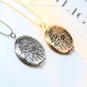 Detail of gold and silver oval locket necklaces with vintage daisy flower relief patterns