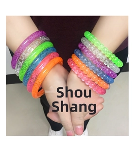 Close-up of colorful LED acrylic bracelets with transparent bubble texture on wrist