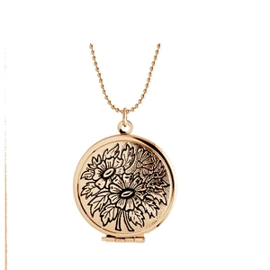 Detail of rose gold floating locket pendant with intricate black floral engraving on bead chain
