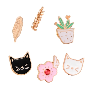 Set of 6 cartoon enamel pins featuring feathers leaves cats and plants with gold borders