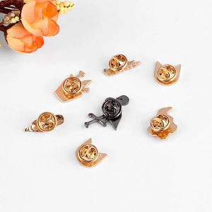 Golden and black enamel pin backs with butterfly clutches for cartoon brooches
