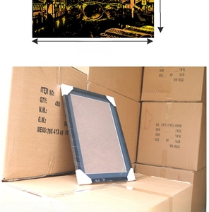 Close-up of black frame with protective corners and transparent shrink wrap packaging