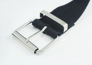 Detailed close-up of high-density black canvas belt with polished silver metal buckle