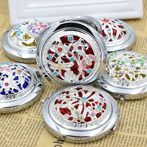 Detailed close-up of hollowed-out vintage metal mirrors with colorful rhinestones