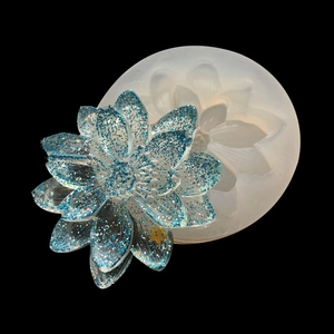 Macro detail of lotus daisy silicone mold with blue glitter resin flower accessories