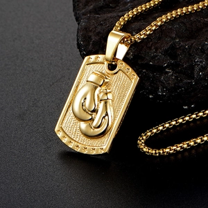 Men's gold boxing glove dog tag pendant on a sleek box chain over black stone