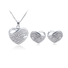 Detailed view of silver heart jewelry set with white cubic zirconia necklace and earrings