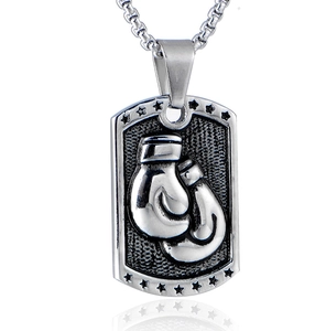 Detailed view of textured metal boxing glove pendant on a dog tag chain with star motif