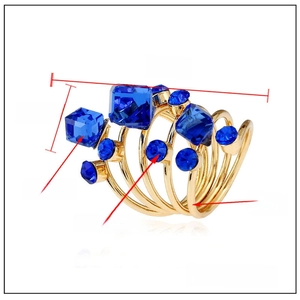 Exaggerated spiral alloy ring featuring blue crystals and rhinestones on white background