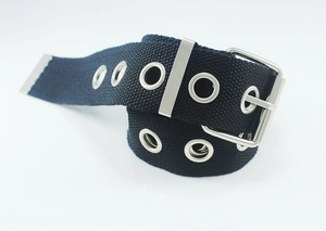 Detail of black canvas belt featuring silver double grommets and metal square buckle
