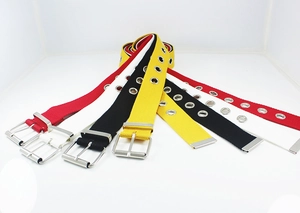 Detail view of colorful canvas belts with metal eyelets and classic pin buckle design