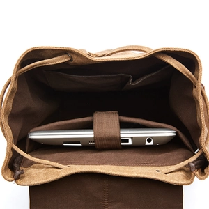 Brown canvas travel backpack with padded laptop compartment and interior organizer pockets