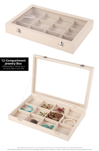 Detail of 12-slot beige velvet jewelry box with glass lid and secure metal lock
