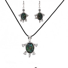 Silver turtle jewelry set with abalone shell inlays on black cord necklace and earrings