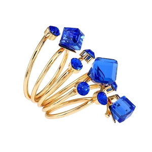 Detailed view of multilayer gold spiral ring featuring deep blue crystal gemstones