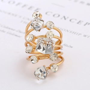 Detail shot of golden multi-layer spiral ring with clear square and round crystals