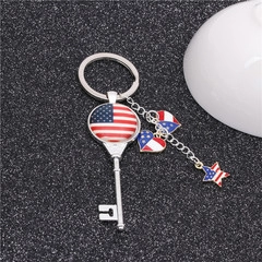 Detailed view of silver metal keychain with heart and star charms in USA flag pattern