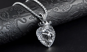 Macro shot of silver titanium steel lion head pendant with a classic box chain