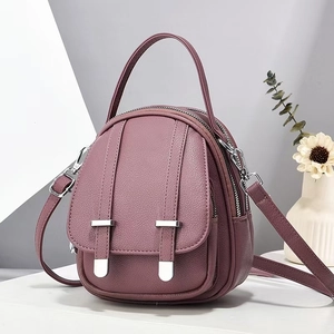 Detail of purple lychee texture crossbody bag with silver buckles and dual zippers
