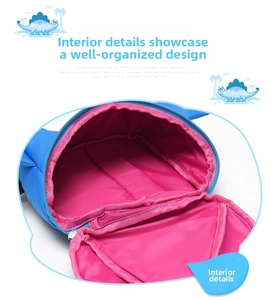 Detail view of the spacious pink interior lining and zipper of the blue dinosaur backpack
