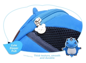 Detail of blue kids backpack featuring cute bear shaped metal zipper and durable nylon mesh