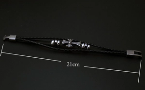 Detail of multi-strand braided black leather bracelet with silver cross and 21cm length