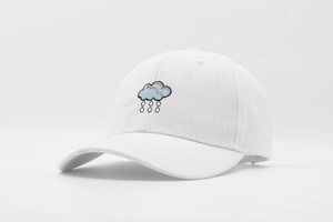 Detail of white breathable baseball cap featuring cloud and raindrop embroidery art