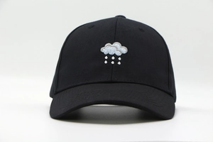 Detail of high-density cotton fabric and cloud rain embroidery on black baseball cap