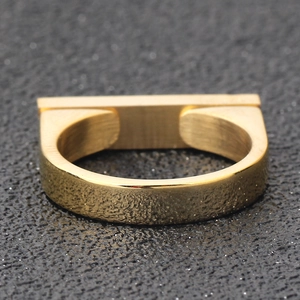 Macro detail of 4mm flat gold titanium steel ring featuring minimalist double rivet design