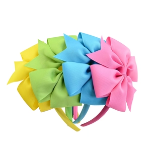 Set of four colorful ribbed bow headbands in yellow, green, blue and pink for girls