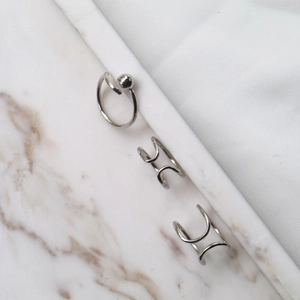 Detail of minimalist S925 sterling silver double-line ear cuffs and beaded open ring