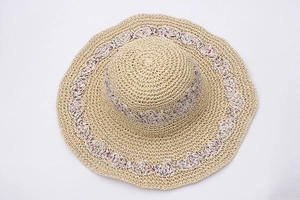 Handmade woven straw sun hat for women with pink floral ribbon and wide wavy brim