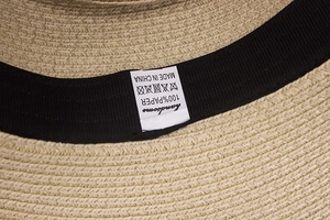 Close-up of beige summer straw hat interior with 100% paper fiber and sweatband