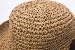 Handwoven raffia straw sun hat for women featuring a minimalist wide brim and fine texture