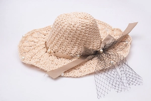 Détails du chapeau de paille à bord ondulé avec perles blanches et voile en tulle noir