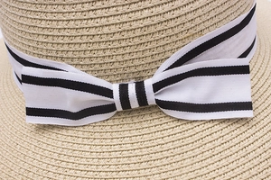 Women's beach sun hat with straw weave texture and black-white striped bow detail