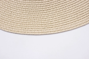 Close-up of the intricate spiral woven pattern and texture on a beige straw sun hat