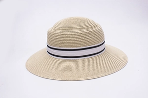 Close-up of beige woven sun hat with white and black striped ribbon bow detailing