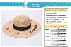 Detail of raffia sun hat featuring black ribbon bow and pink ladybug embroidery